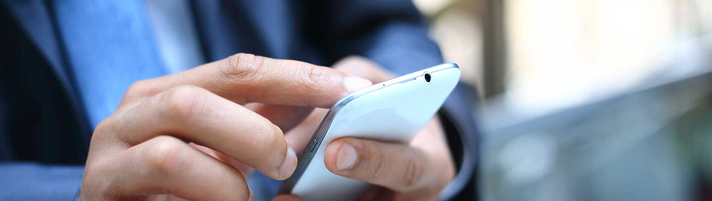 image of a man checking his mobile phone