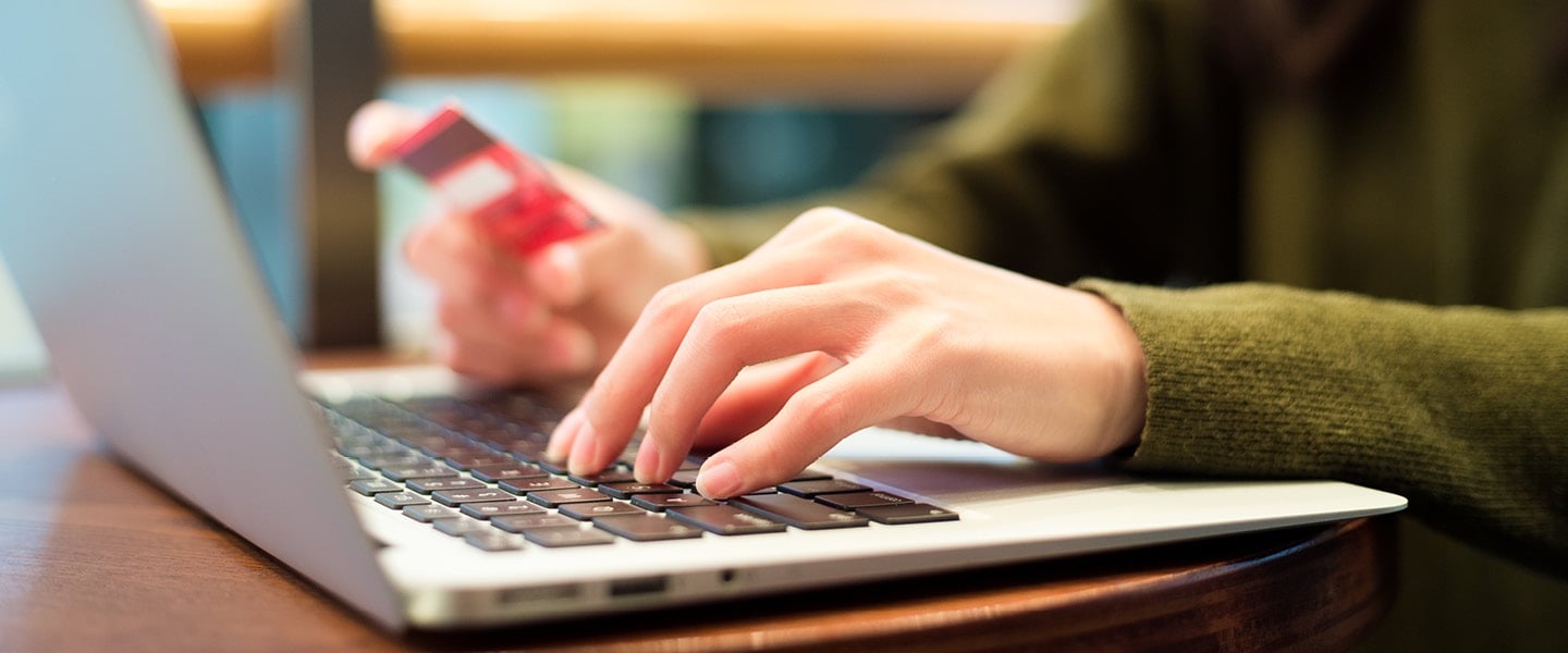 Woman using laptop for booking ticket