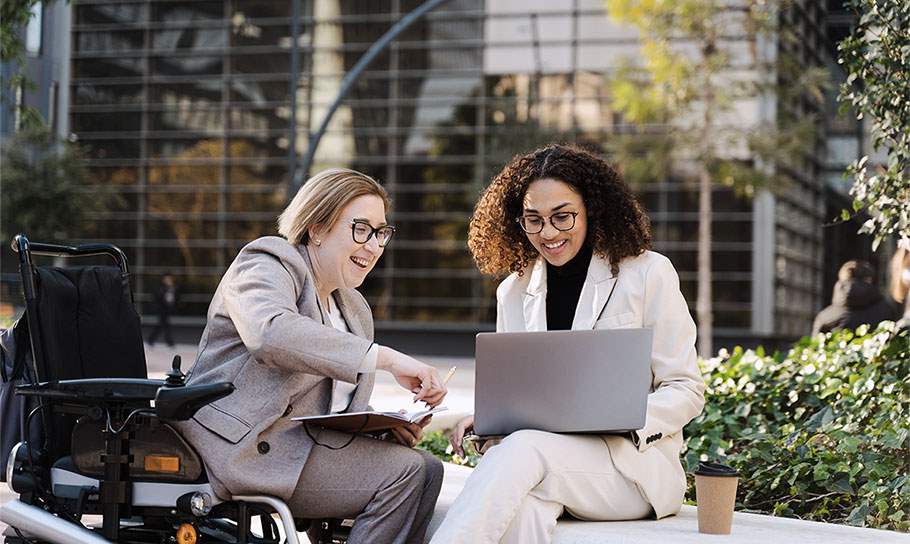 Two women talking over work